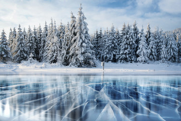 Wall Mural - Blue ice and cracks on the surface of the .