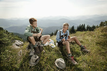 Germany, Bavaria, Two Boys Resting In Mountains