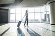 © F8  \ Suport Ukraine - Woman with lagguge in international airport walking in terminal