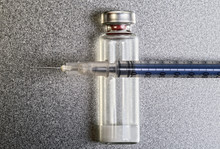 Pen Medical Syringe, One Ampule With Dry Human Hormone Drug Powder, Forbidden Sportsmen Doping. Blue Syringe Lying On The Vial With Drug. Macro Image. Stainless Steel Background.