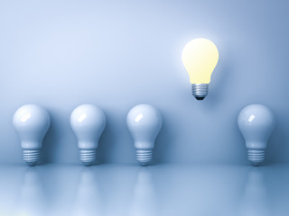 Fototapete - One glowing light bulb standing out from the unlit incandescent bulbs on blue background with reflection individuality and different creative idea concepts 3D rendering