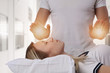 © dream@do - Woman having reiki healing treatment , alternative medicine concept.