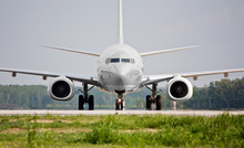Front View Of White Plane Before Takeoff On The Runway. Passenger Airliner Takes Off. Passenger Commercial Air Transportation. Mid-range Aircraft. Spotting In The Airport.