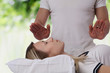 © dream@do - Woman having reiki healing treatment , alternative medicine concept.