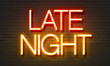 © ibreakstock - Late night neon sign on brick wall background.
