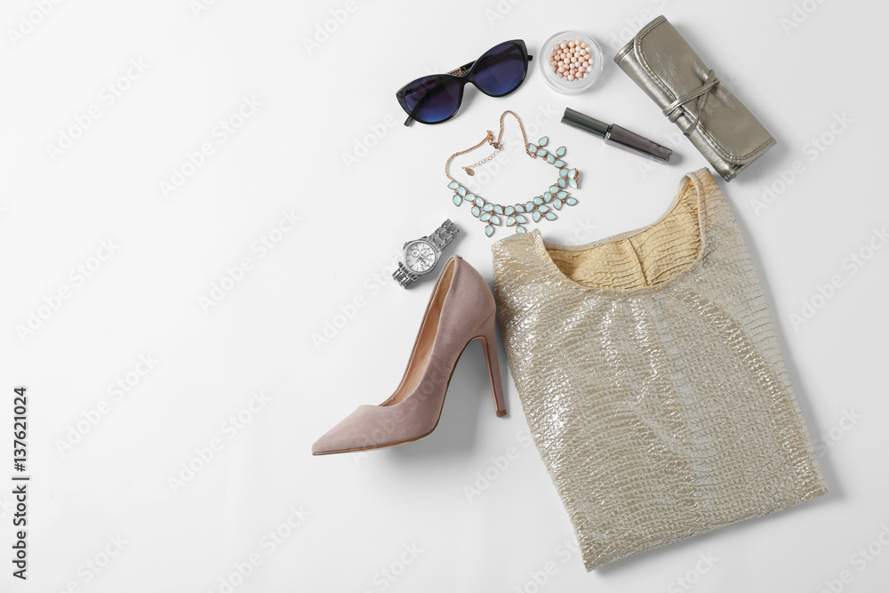 Flat lay set of female clothes and accessories on white background