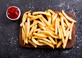 Wall Mural - French fries with ketchup on dark table