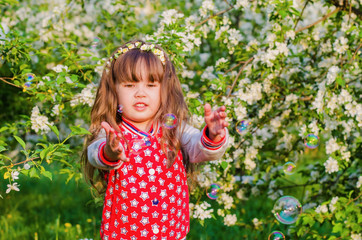 Wall Mural - girl playing with soap bubbles