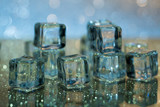 Fototapeta Kuchnia - Melting ice cubes on glass table