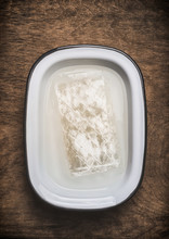 Transparent Sheets Of Gelatine In Water Bowl On Wooden Background, Top View, Close Up