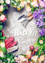 Gardening Background With Assortment Of Colorful Garden Flowers In Pots , Tools, And Handwritten Text Happy Garden, Top View