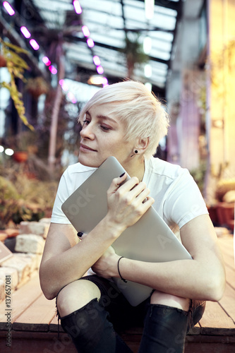 Young Hipster Woman With Blonde Short Hair Sitting On Stairs