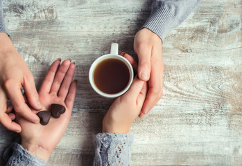 lovers holding together a Cup of tea. Selective focus.  