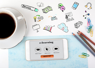 Wall Mural - e-learning Concept. Mobile phone and coffee cup on a white office desk.