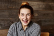 © wayhome.studio  - Omg! Beautiful young female with hair bun having joyful look, smiling cheerfully, happy with some positive news. Attractive redhead woman looking contented while relaxing alone at coffee shop