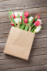 Wall Mural - Colorful tulips in paper bag