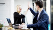 © filmovar - Business People are Looking at a Screen and Make a Deal