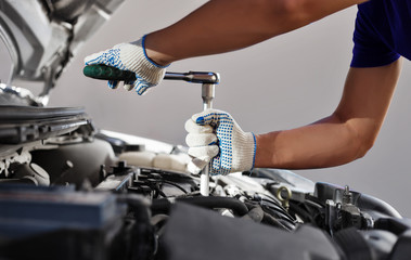 Mechanic working in auto repair garage. Car maintenance