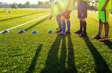 Wall Mural - Soccer Football Training Session for Kids. Boys Training Football on the Pitch. Soccer Stadium in the Background