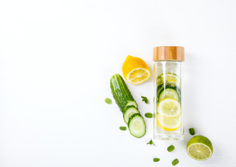  Detox Infused Water with Lemon, Lime,Cucumber and Mint in Sports Glass Bottle on a White Background.Healthy Beverage.Food  diet concept.Vegetarian.Copy space for Text. selective focus.
