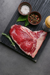 Sticker - Raw steak with spices on cutting board