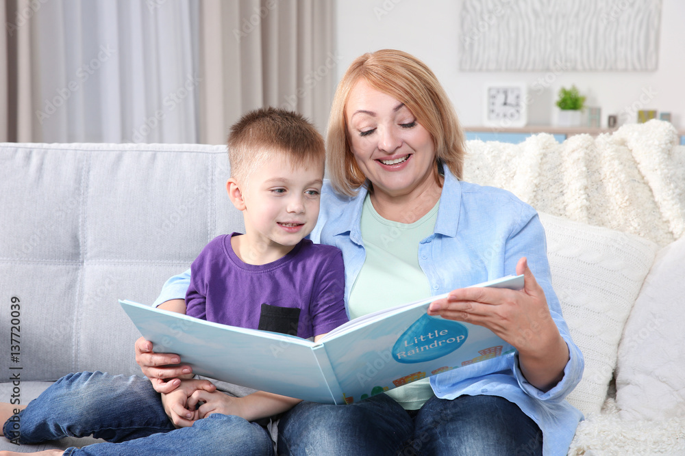 Grandmother reading her grandson book