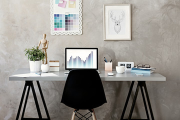 Wall Mural - Workplace with laptop on table in modern room