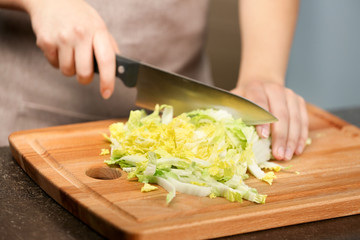 Sticker - Female hands cutting Chinese cabbage at table in kitchen