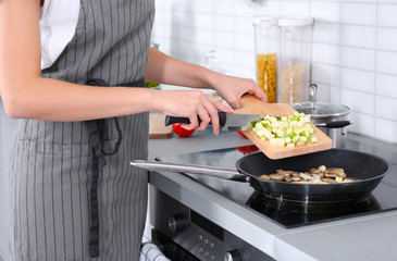 Wall Mural - Woman cooking delicious dinner at home