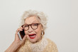 © Yakobchuk Olena - Excited mature lady speaking by mobile