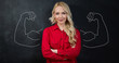 © Myvisuals - Young woman against the background of depicted muscles on chalkboard