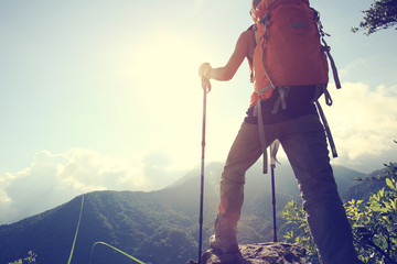 young woman hiker hiking on mountain peak