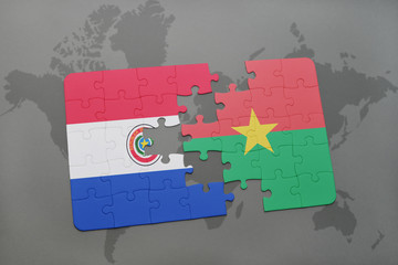 puzzle with the national flag of paraguay and burkina faso on a world map