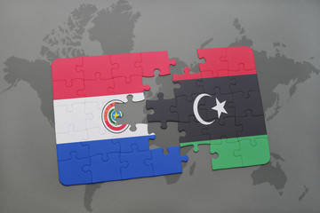 puzzle with the national flag of paraguay and libya on a world map