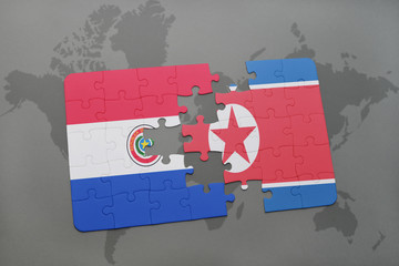 puzzle with the national flag of paraguay and north korea on a world map