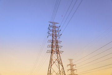 High voltage electricity pylon system, Electricity transmission power lines at sunset