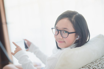 Wall Mural - Asian girl using earphone for listen music