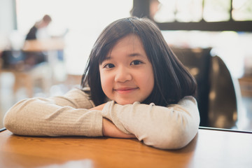 Wall Mural - portrait of beautiful Adsian girl smiling in a coffee shop