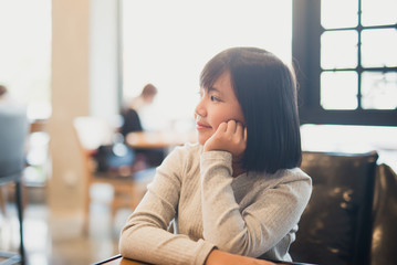 Wall Mural - portrait of beautiful Adsian girl smiling in a coffee shop