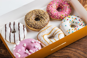 glazed donuts with different fillings in the box