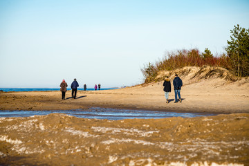 Wall Mural - people enjoying frozen beach