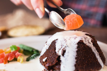 Decorating cake with marmalade closeup. Confectioner finishing his sweet cake with final ingredient, free space. Confectionery, sugar, dessert cooking concept