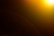 Lens flare and light beam on dark background yellow color style , photo from lens camera
