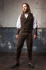 Handsome male Steam punk. Retro man portrait over grunge background.