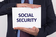 © relif - Man showing paper with SOCIAL SECURITY text