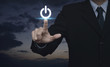 © grapestock - Businessman pressing power button over sunset sky, Start up business concept