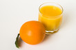 Oranges and glass of juice on a white background.