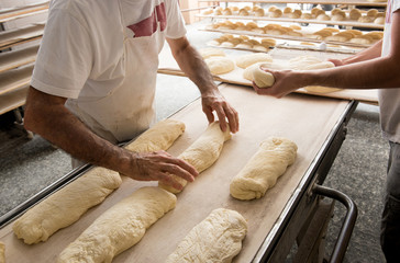 Wall Mural - Bakers putting bread to a band for oven