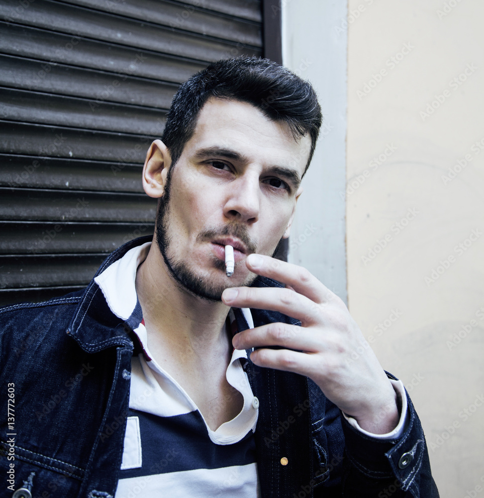 middle age man smoking cigarette on bacyjard, stylish tough guy, Stock  Photo