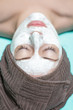 © producer - beautician applies face mask on young woman in Spa salon. cosmet